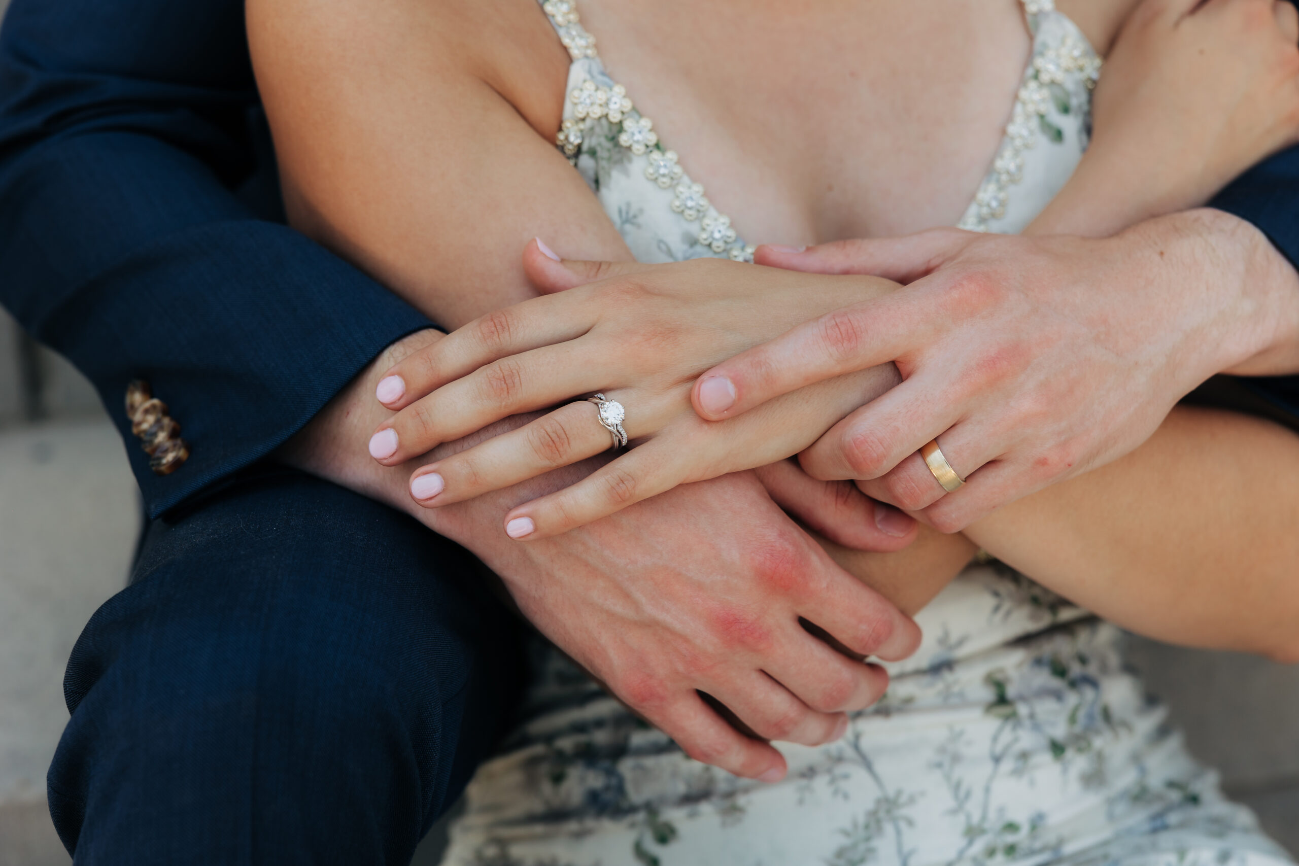 A detailed look at wedding bands and engagement ring—capturing the beauty of a meaningful moment that helped them save money for their Colorado elopement.